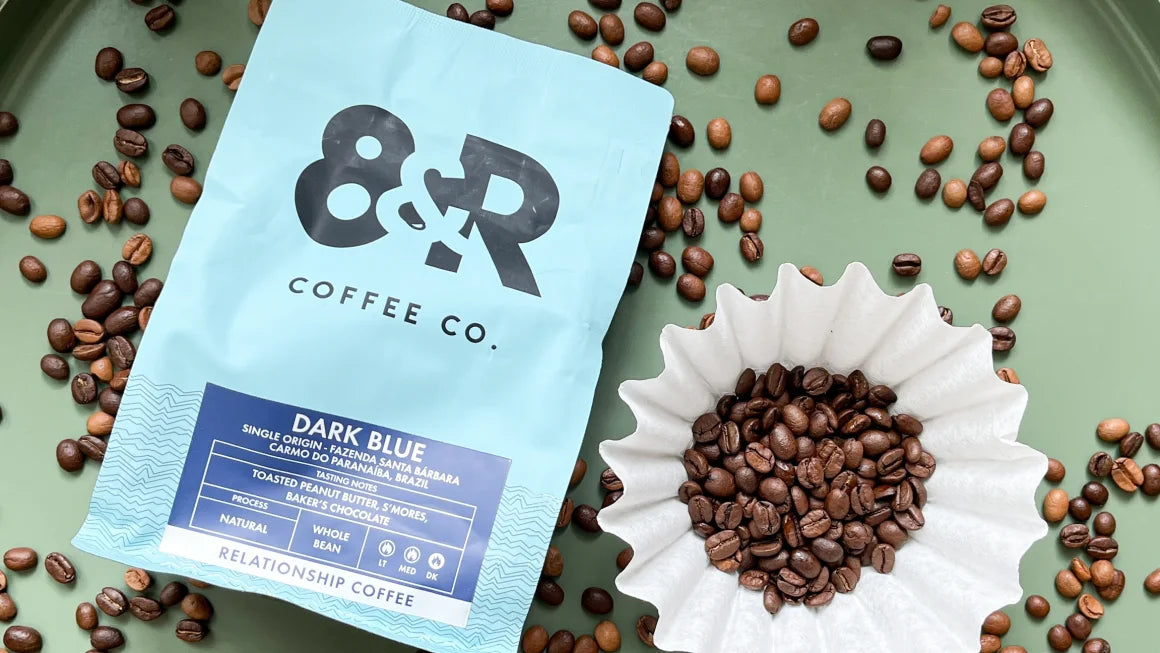 Photo of 8th & Roast coffee with scattered coffee beans and a coffee filter