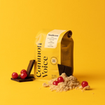 Sunbeam coffee bag on a yellow background next to cherries, chocolate, and brown sugar